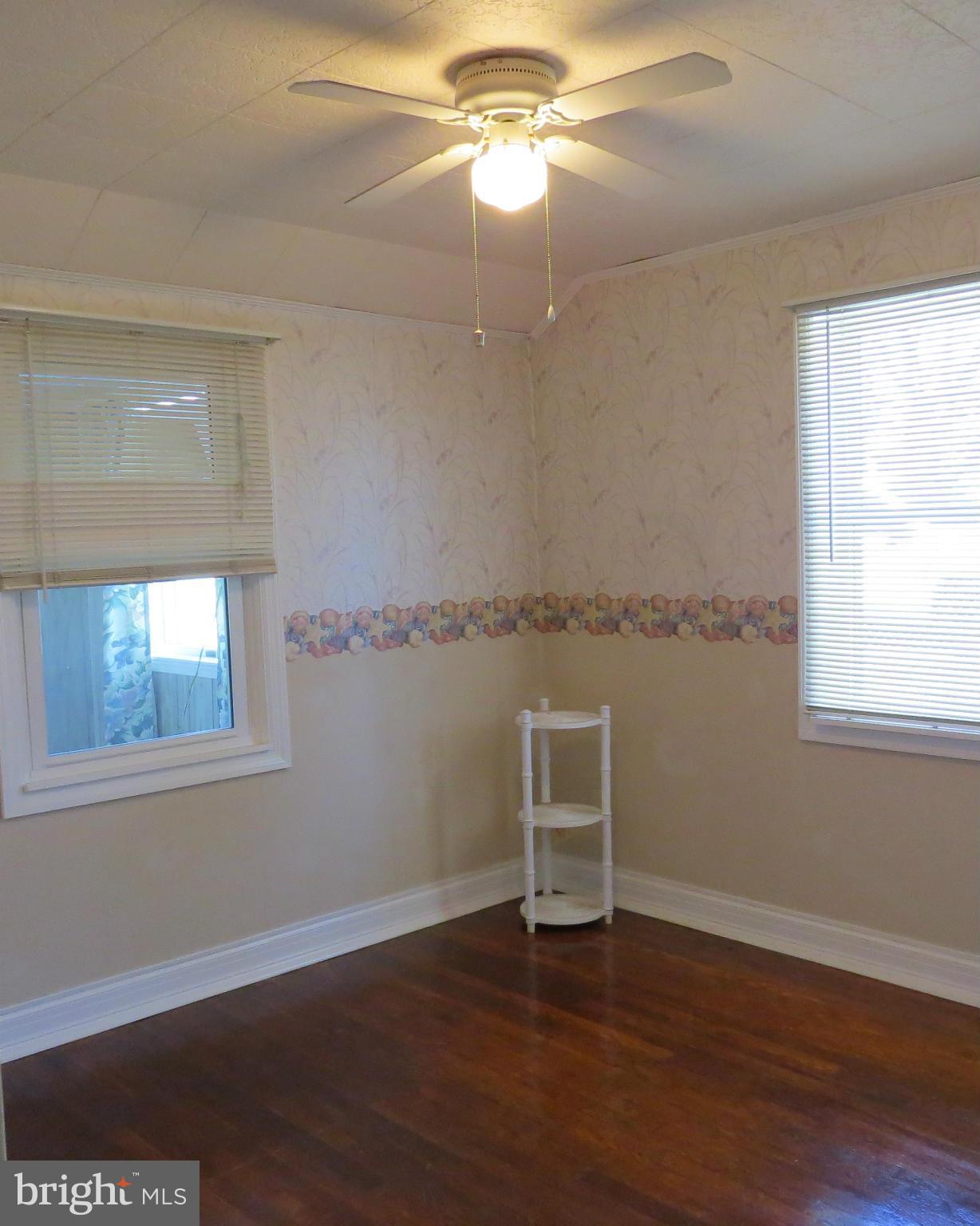 3401 Sollers Point Road Baltimore, MD 21222 - Photo 20 of 29 a view of an empty room with wooden floor and a window
