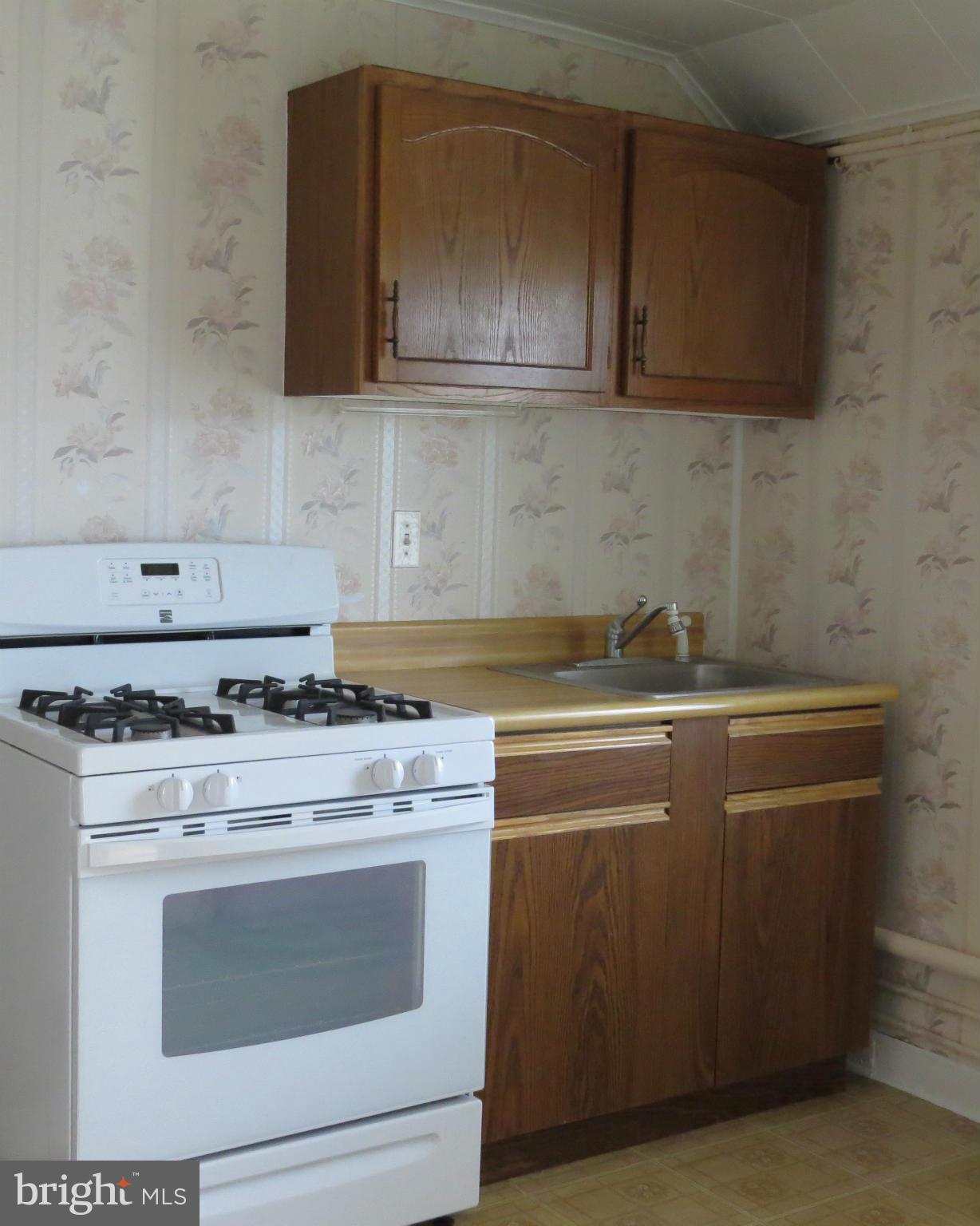 3401 Sollers Point Road Baltimore, MD 21222 - Photo 7 of 29 a stove top oven sitting inside of a kitchen