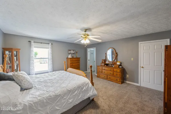 a bedroom with a large bed and a chandelier
