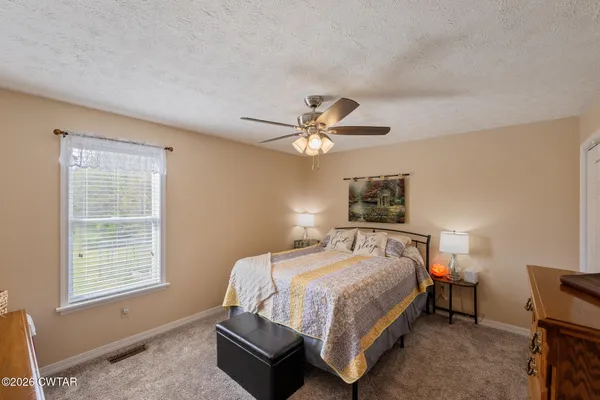 a bedroom with a bed and a window