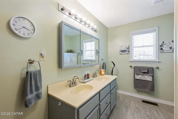 a bathroom with a sink vanity and a mirror