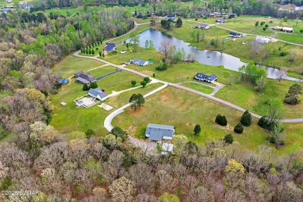 a view of a tennis ground with lots of trees