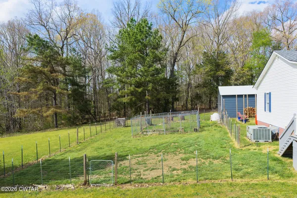 a backyard of a house with table and chairs