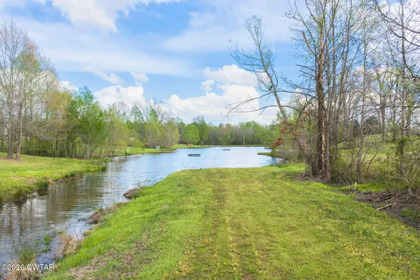 a view of a lake with houses in the background