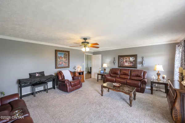 a living room with furniture and a piano