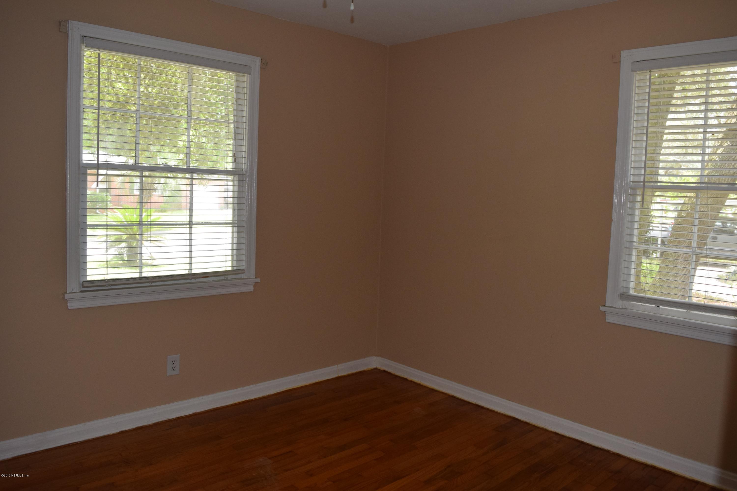 5604 Stetson Road Jacksonville, FL 32207 - Photo 14 of 18 a view of an empty room with wooden floor and a window
