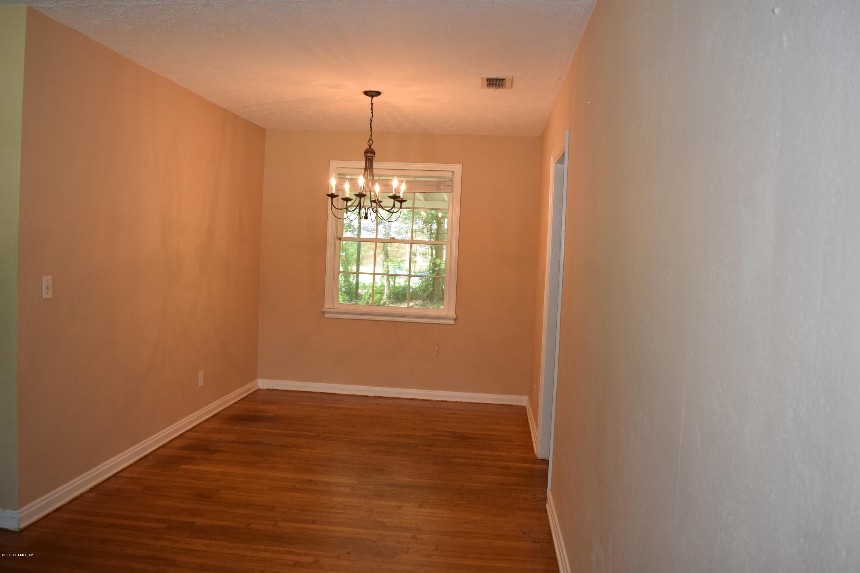 5604 Stetson Road Jacksonville, FL 32207 - Photo 8 of 18 an empty room with wooden floor fan and window