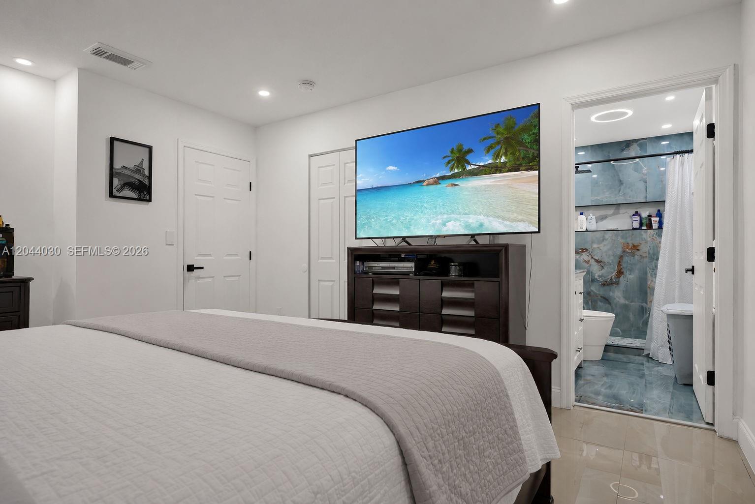12551 Southwest 223rd Street Miami, FL 33170 - Photo 16 of 35 a bedroom with a bed and a flat screen tv