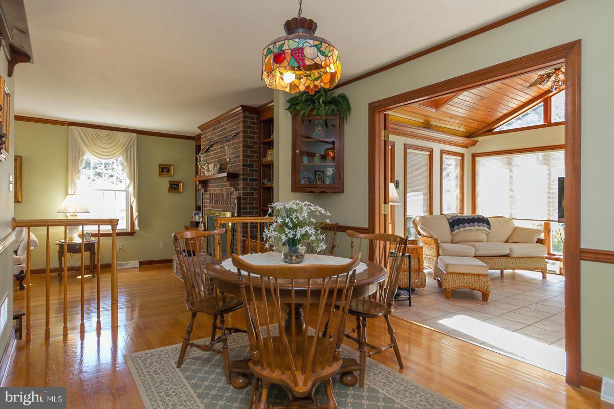 2807 Monkton Road Monkton, MD 21111 - Photo 13 of 30 a dining room with furniture potted plants and wooden floor