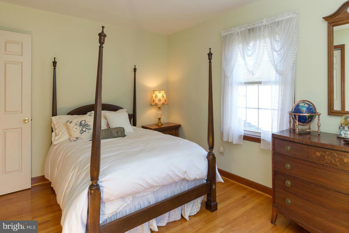 2807 Monkton Road Monkton, MD 21111 - Photo 20 of 30 a bedroom with a bed and wooden floor