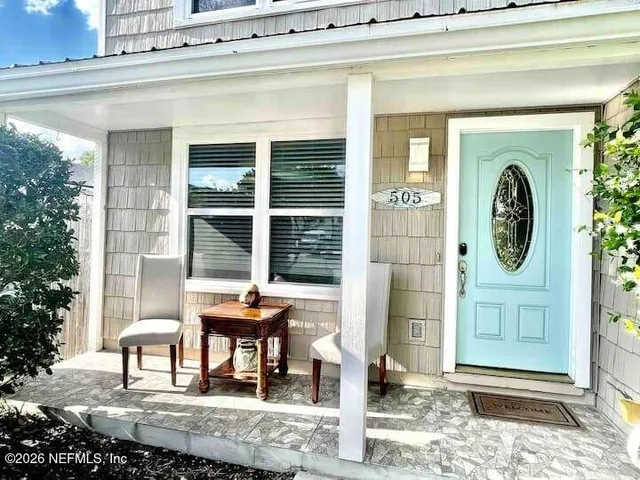 a front view of a house with outdoor seating