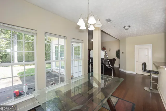 a view of a dining room with furniture wooden floor and chandelier