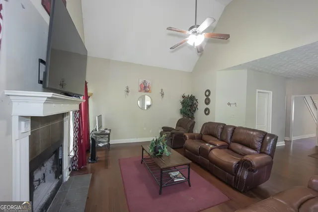 a living room with furniture a fireplace and a flat screen tv