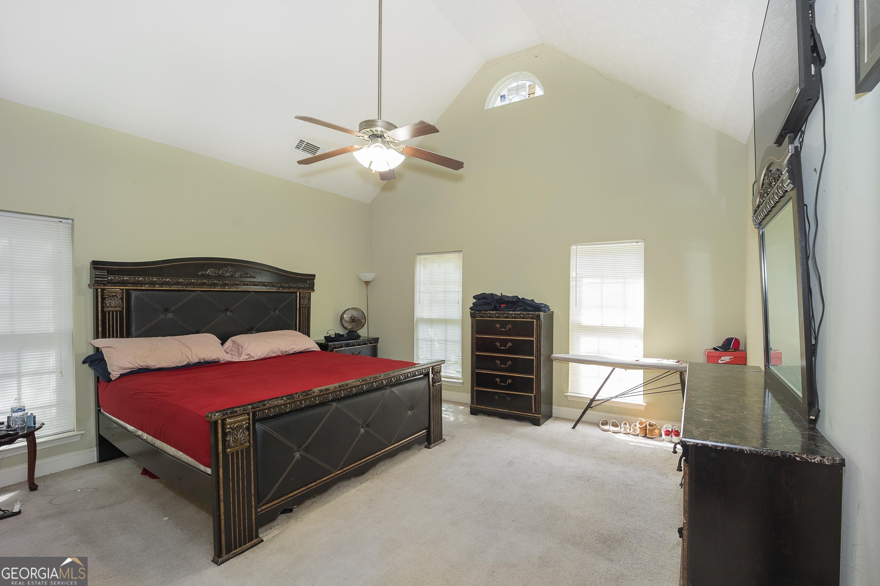 1231 Hillview Road Hampton, GA 30228 - Photo 19 of 45 a bedroom with a bed and a chandelier