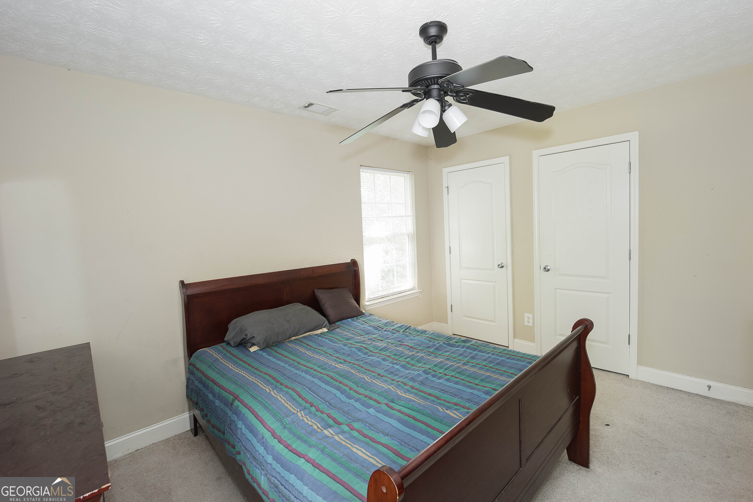 1231 Hillview Road Hampton, GA 30228 - Photo 27 of 45 a bedroom with a bed and a ceiling fan