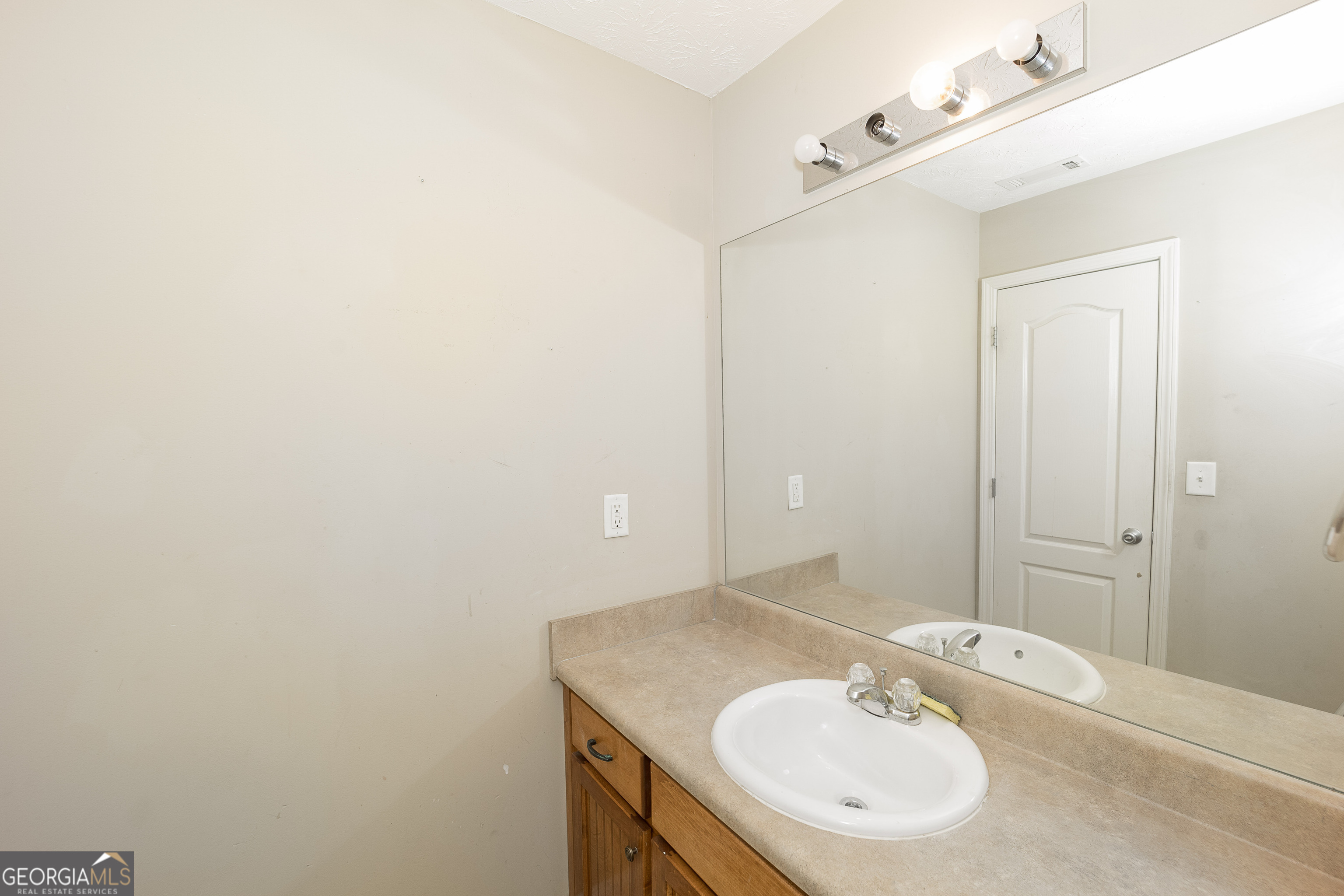 1231 Hillview Road Hampton, GA 30228 - Photo 30 of 45 a bathroom with a sink and a mirror