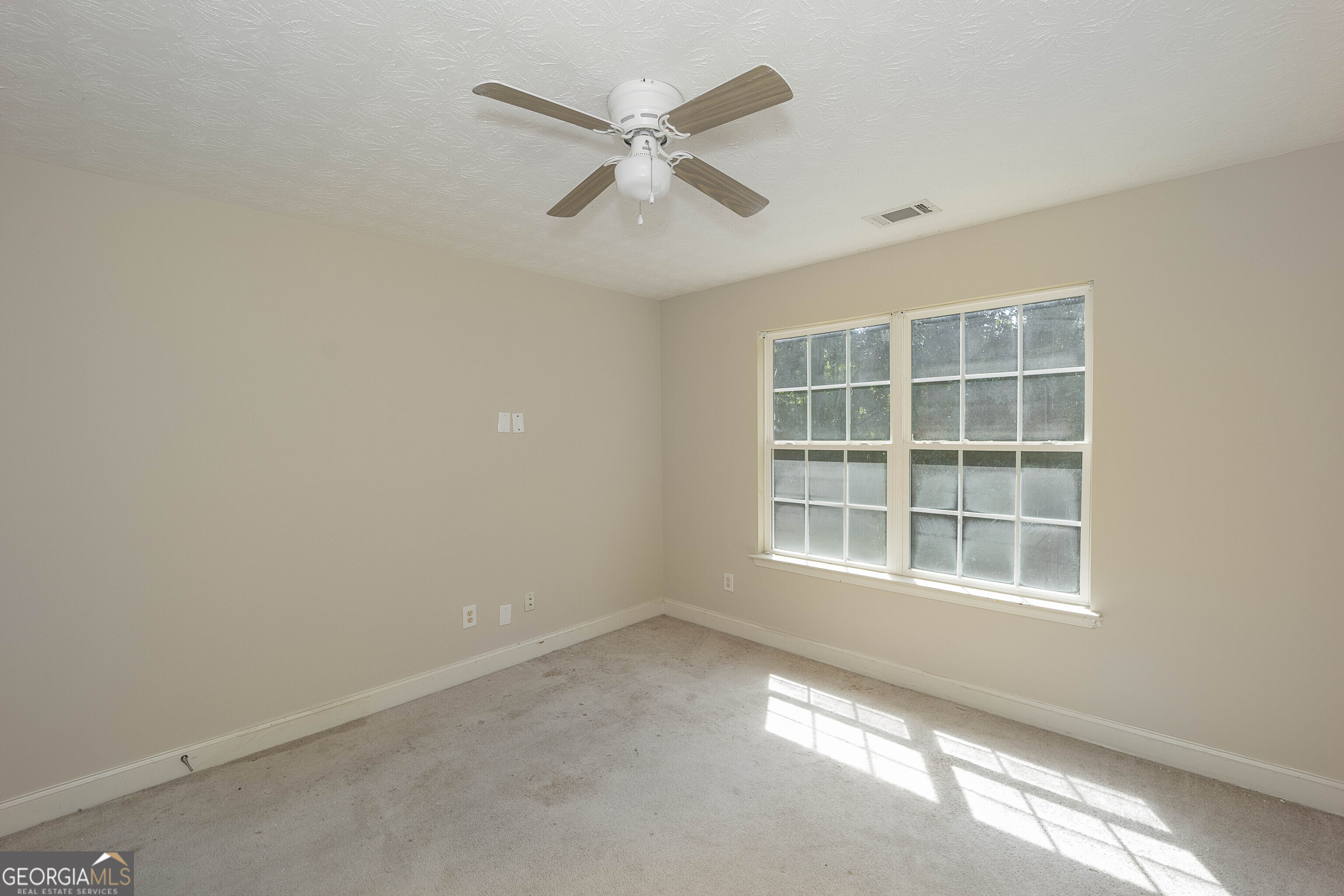 1231 Hillview Road Hampton, GA 30228 - Photo 38 of 45 an empty room with a window and ceiling fan