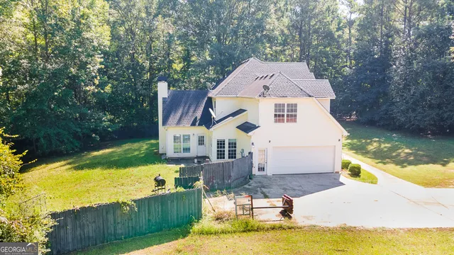 an aerial view of residential house with outdoor space and swimming pool
