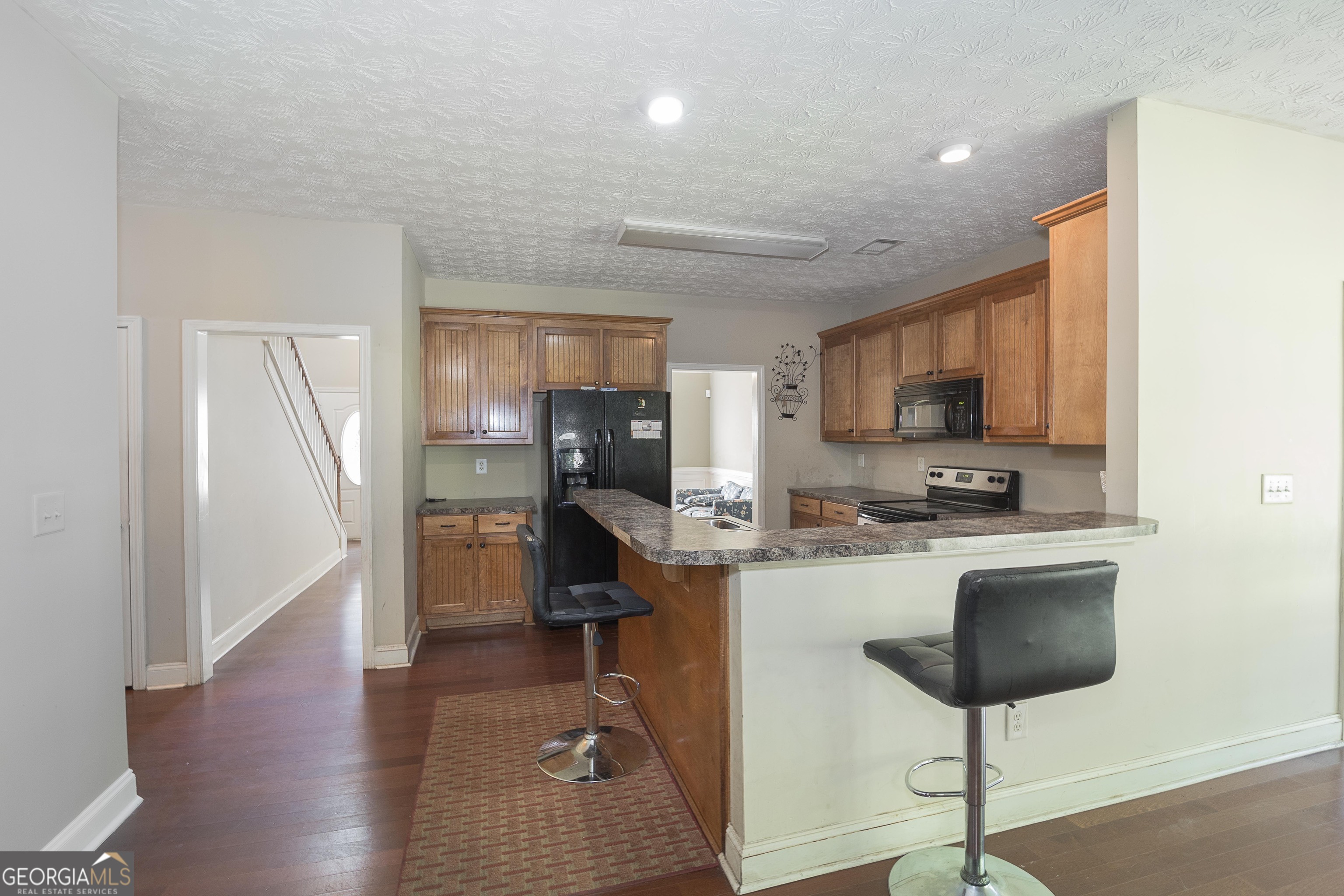 1231 Hillview Road Hampton, GA 30228 - Photo 8 of 45 a view of a kitchen with fridge and wooden floor
