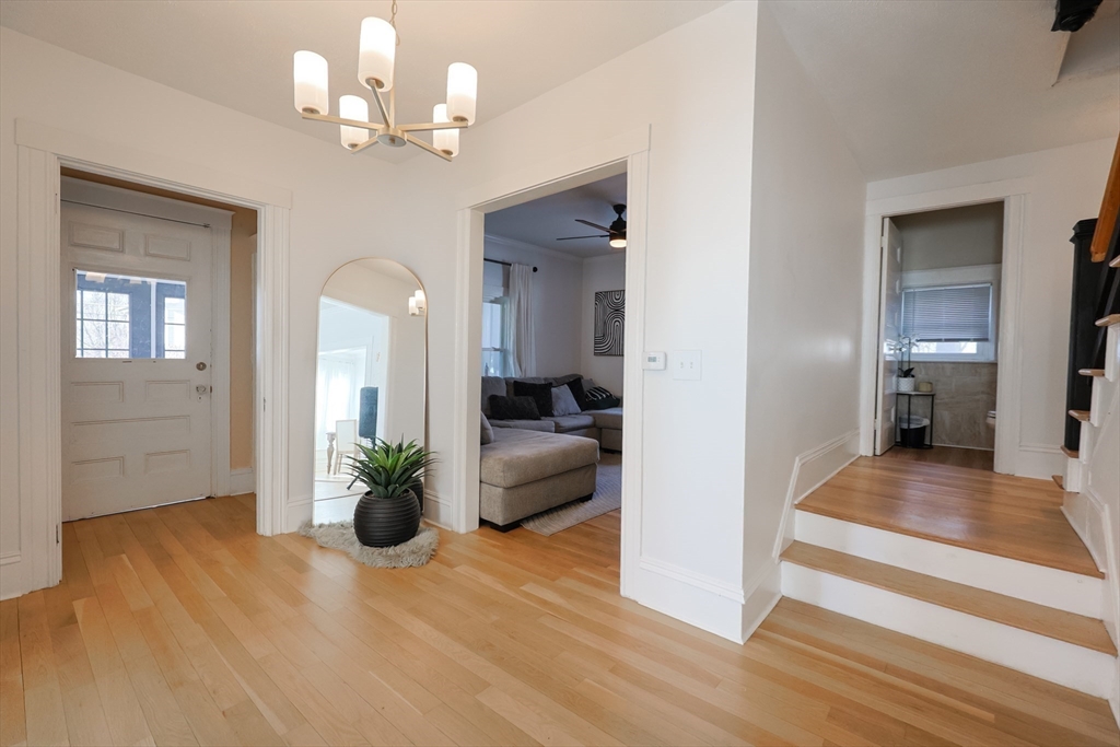 251 High Street Webster, MA 01570 - Photo 16 of 38 a view of a hallway with wooden floor and a chandelier