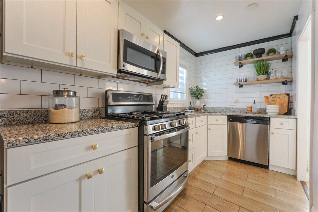 251 High Street Webster, MA 01570 - Photo 20 of 38 a kitchen with sink a microwave and cabinets