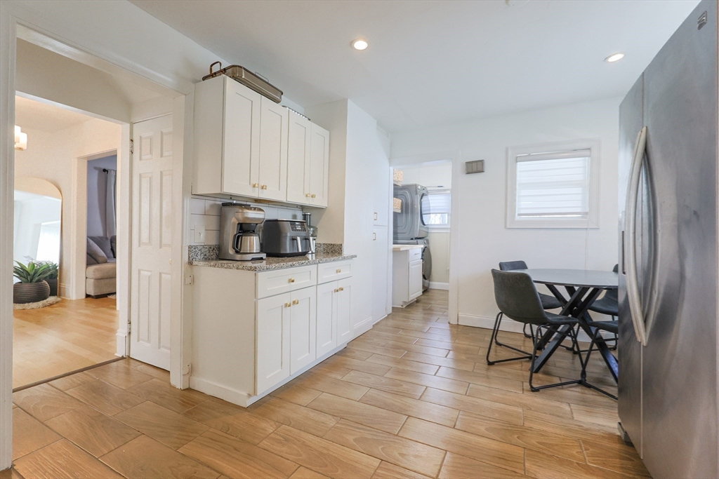 251 High Street Webster, MA 01570 - Photo 22 of 38 a kitchen with stainless steel appliances kitchen island granite countertop a refrigerator and a stove top oven
