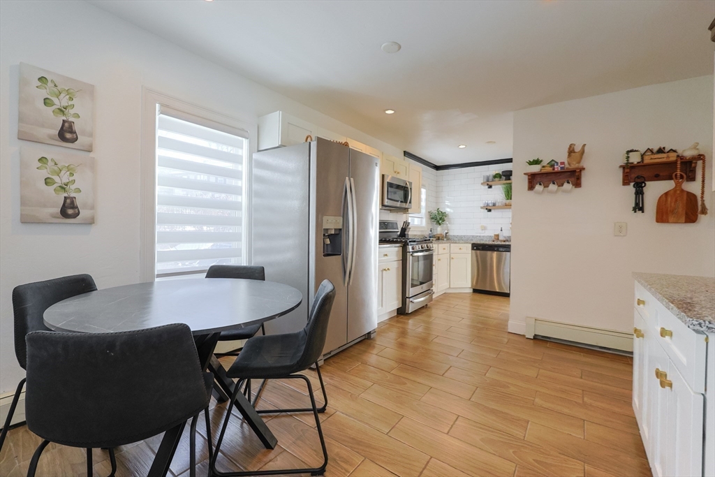 251 High Street Webster, MA 01570 - Photo 23 of 38 a dining room with kitchen island a table and chairs