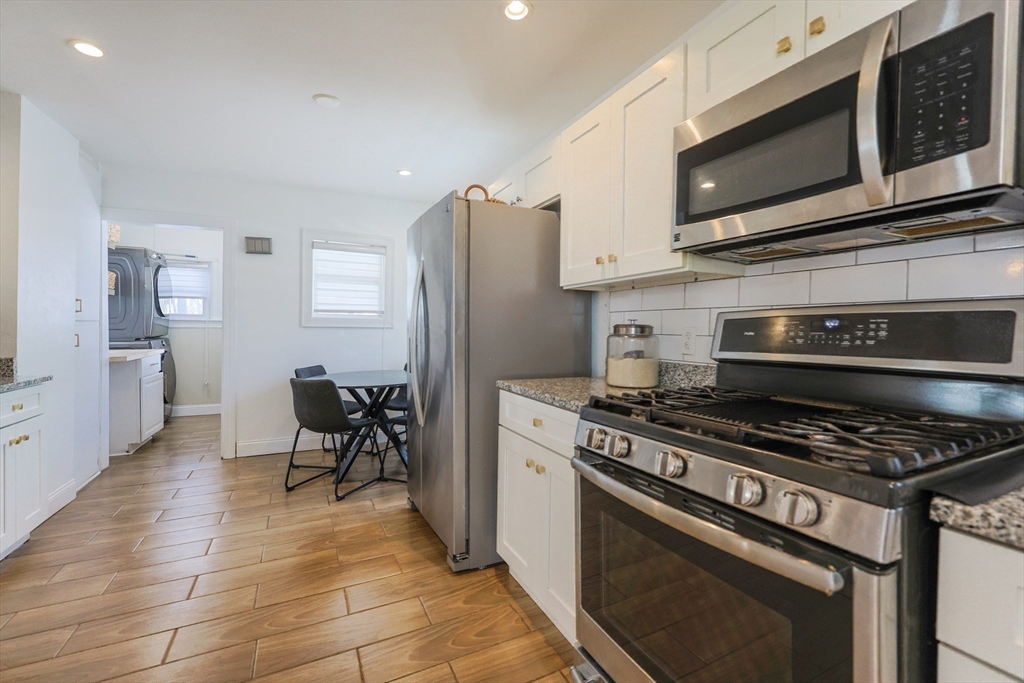 251 High Street Webster, MA 01570 - Photo 24 of 38 a kitchen with stainless steel appliances a stove a microwave and cabinets