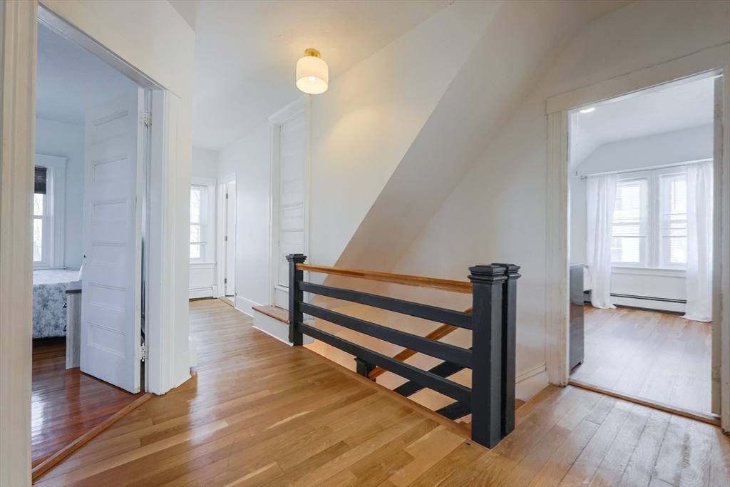 251 High Street Webster, MA 01570 - Photo 27 of 38 a view of a hallway with wooden floor and staircase