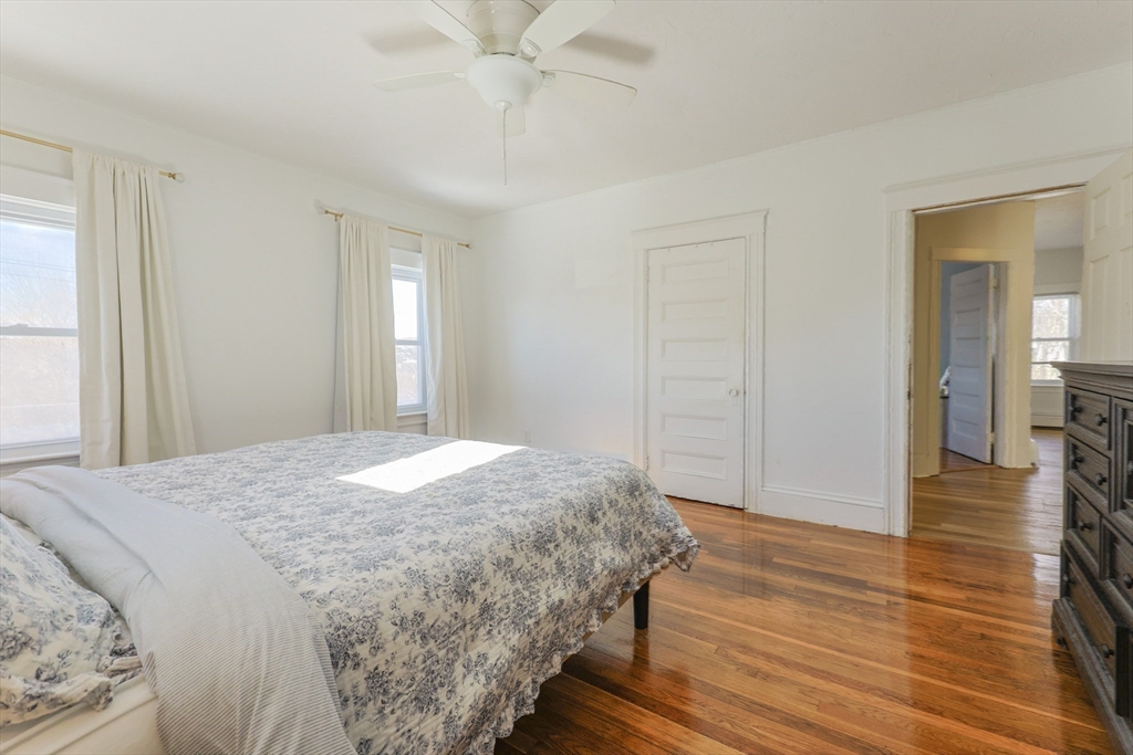 251 High Street Webster, MA 01570 - Photo 32 of 38 a bedroom with a bed and a chandelier