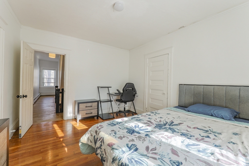 251 High Street Webster, MA 01570 - Photo 34 of 38 a bedroom with a bed and wooden floor
