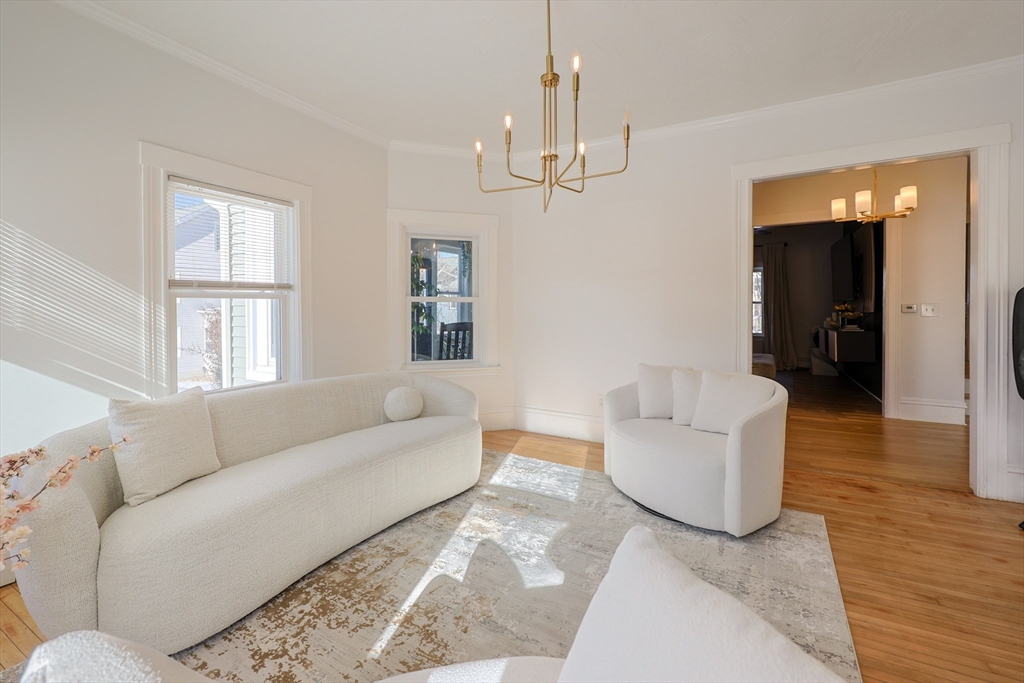 251 High Street Webster, MA 01570 - Photo 10 of 38 a living room with furniture and a chandelier