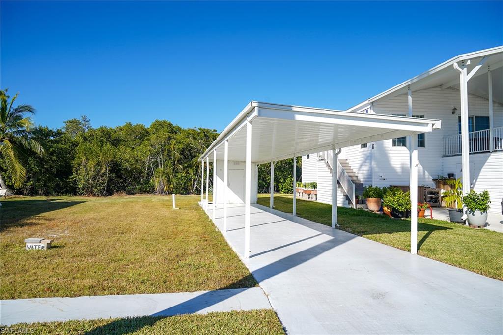 777 Walkerbilt Road Naples, FL 34110 - Photo 3 of 12 a view of swimming pool with tree s