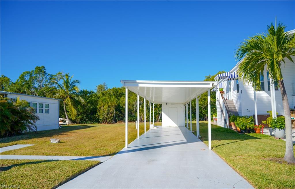 777 Walkerbilt Road Naples, FL 34110 - Photo 4 of 12 a view of a house with backyard and swimming pool