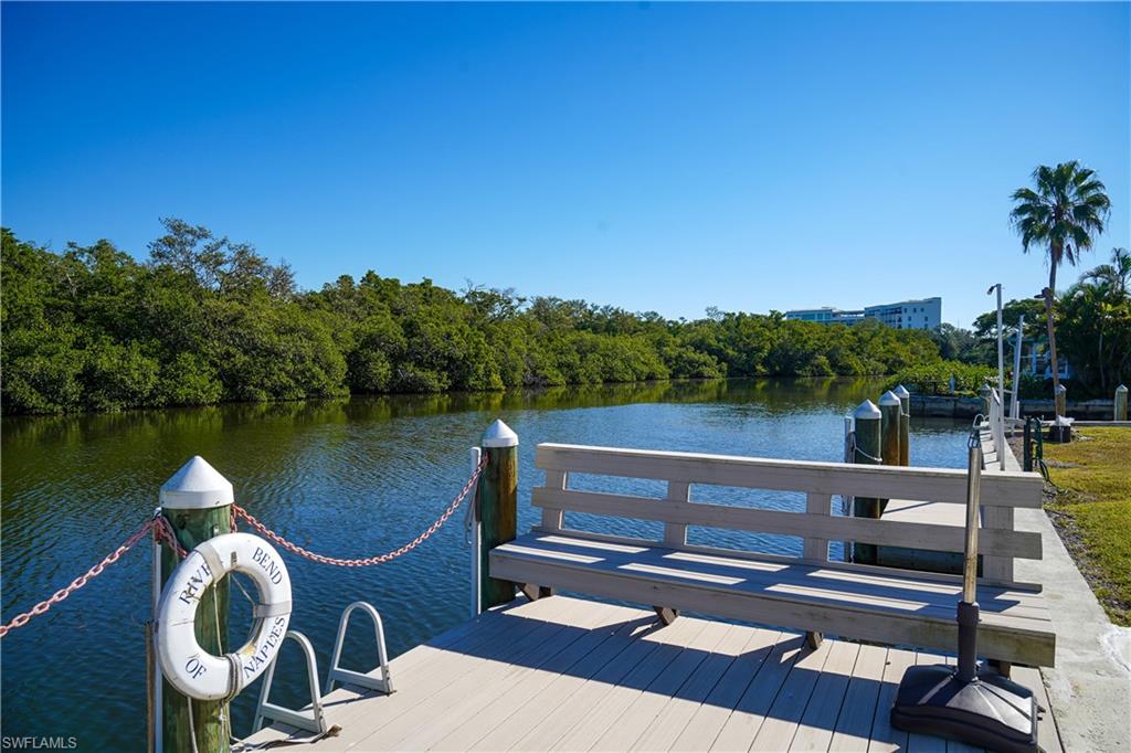 777 Walkerbilt Road Naples, FL 34110 - Photo 9 of 12 a view of swimming pool with seating area and lake view