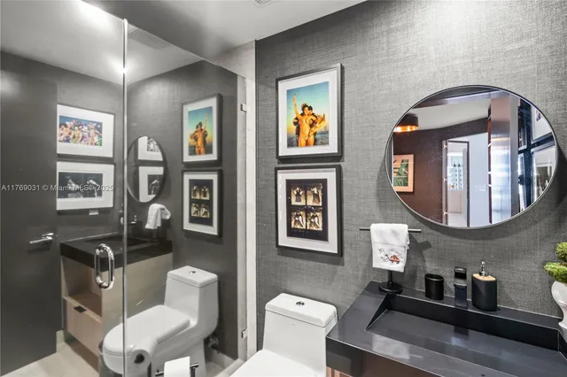 a bathroom with a toilet a sink and mirror