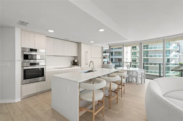 a kitchen with appliances a sink and cabinets