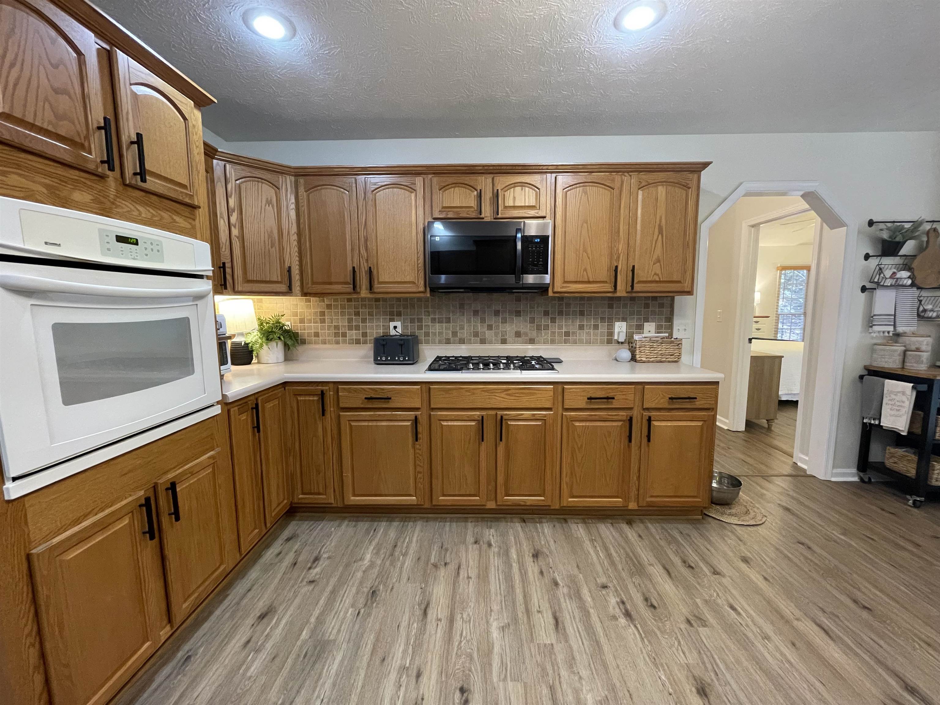 111 Rutherford Lane Stuarts Draft, VA 24477 - Photo 18 of 45 a kitchen with a sink window and cabinets