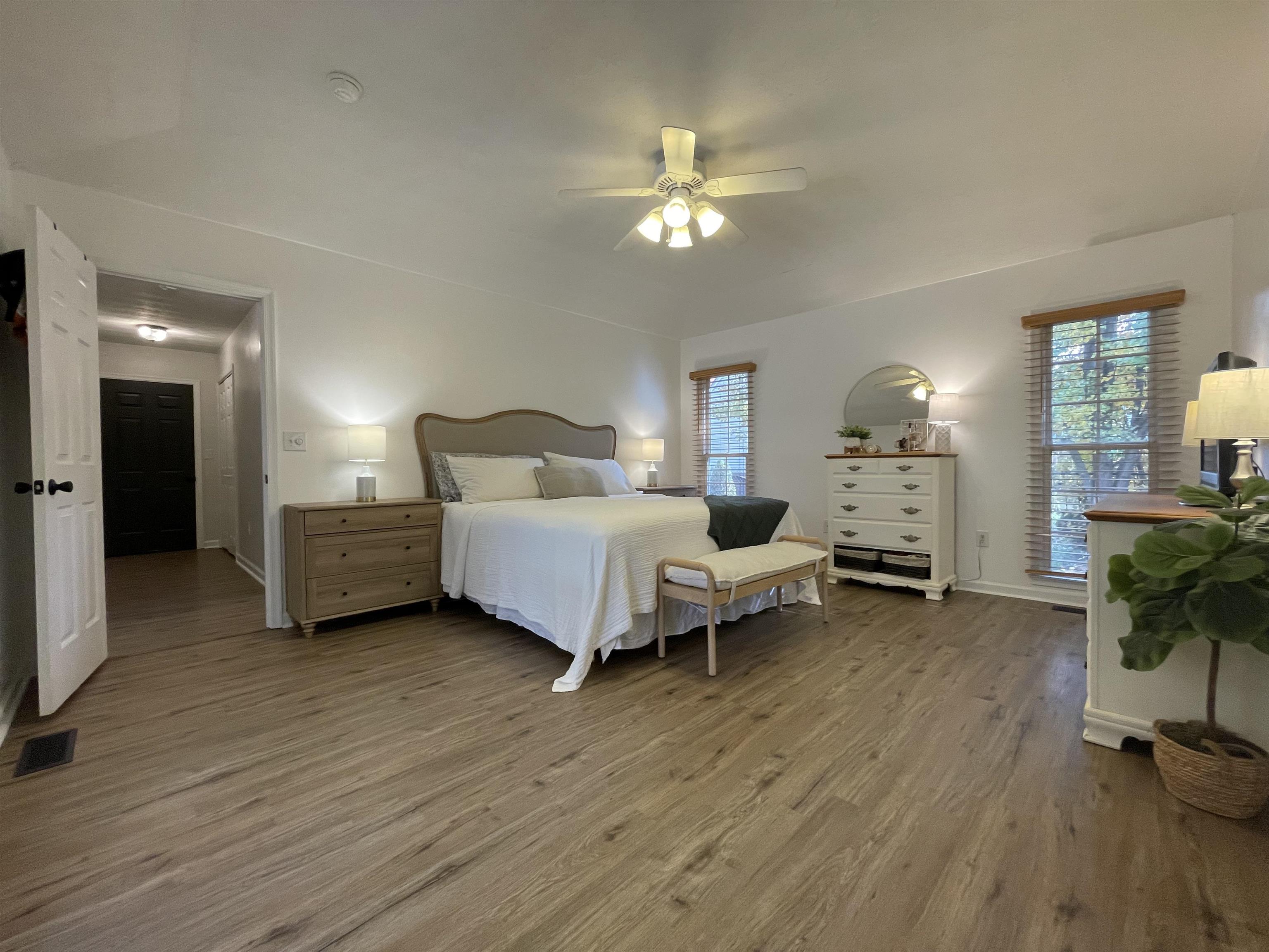 111 Rutherford Lane Stuarts Draft, VA 24477 - Photo 22 of 45 a spacious bedroom with a bed and a chandelier