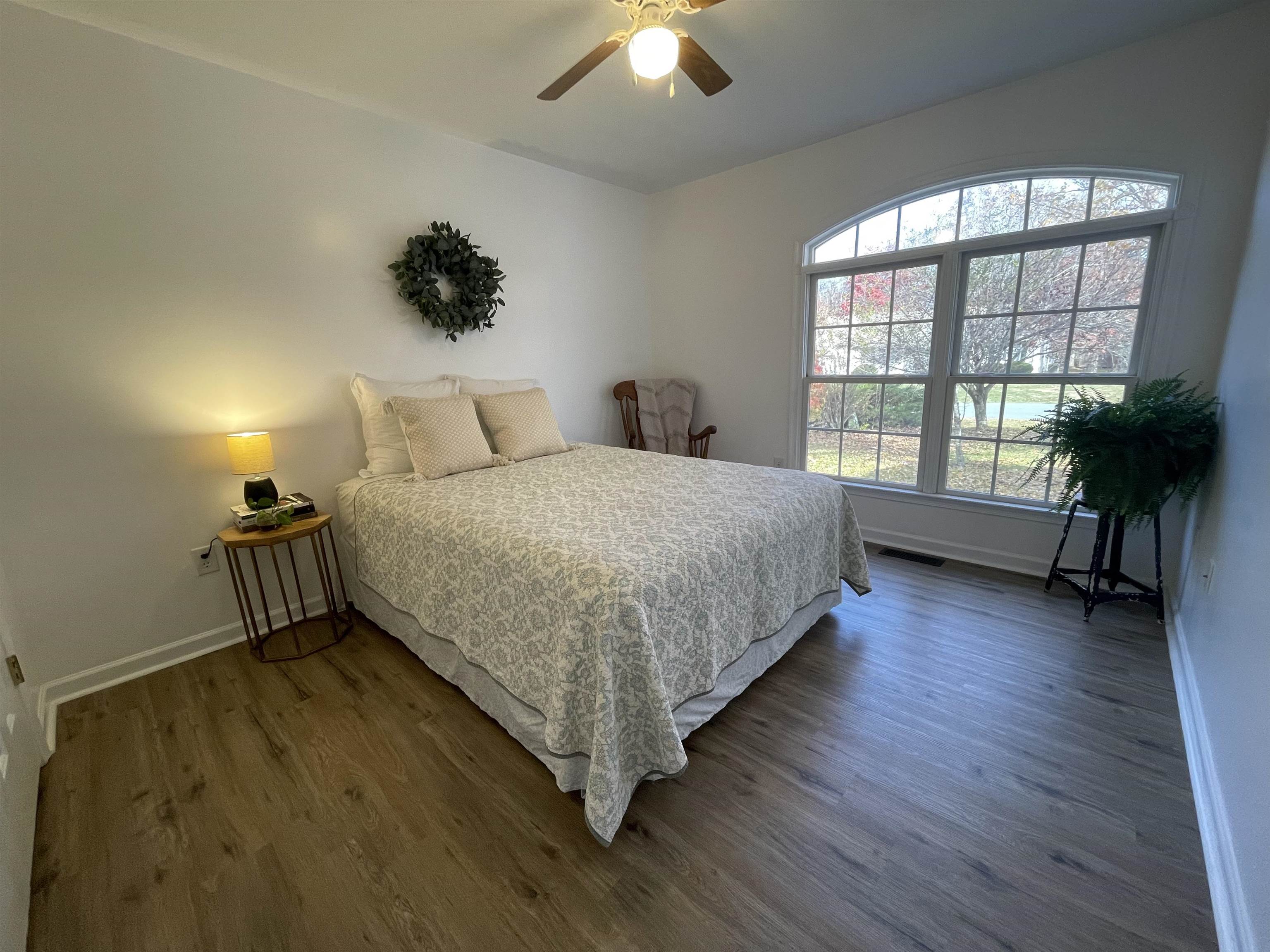 111 Rutherford Lane Stuarts Draft, VA 24477 - Photo 27 of 45 a spacious bedroom with a bed and a chandelier