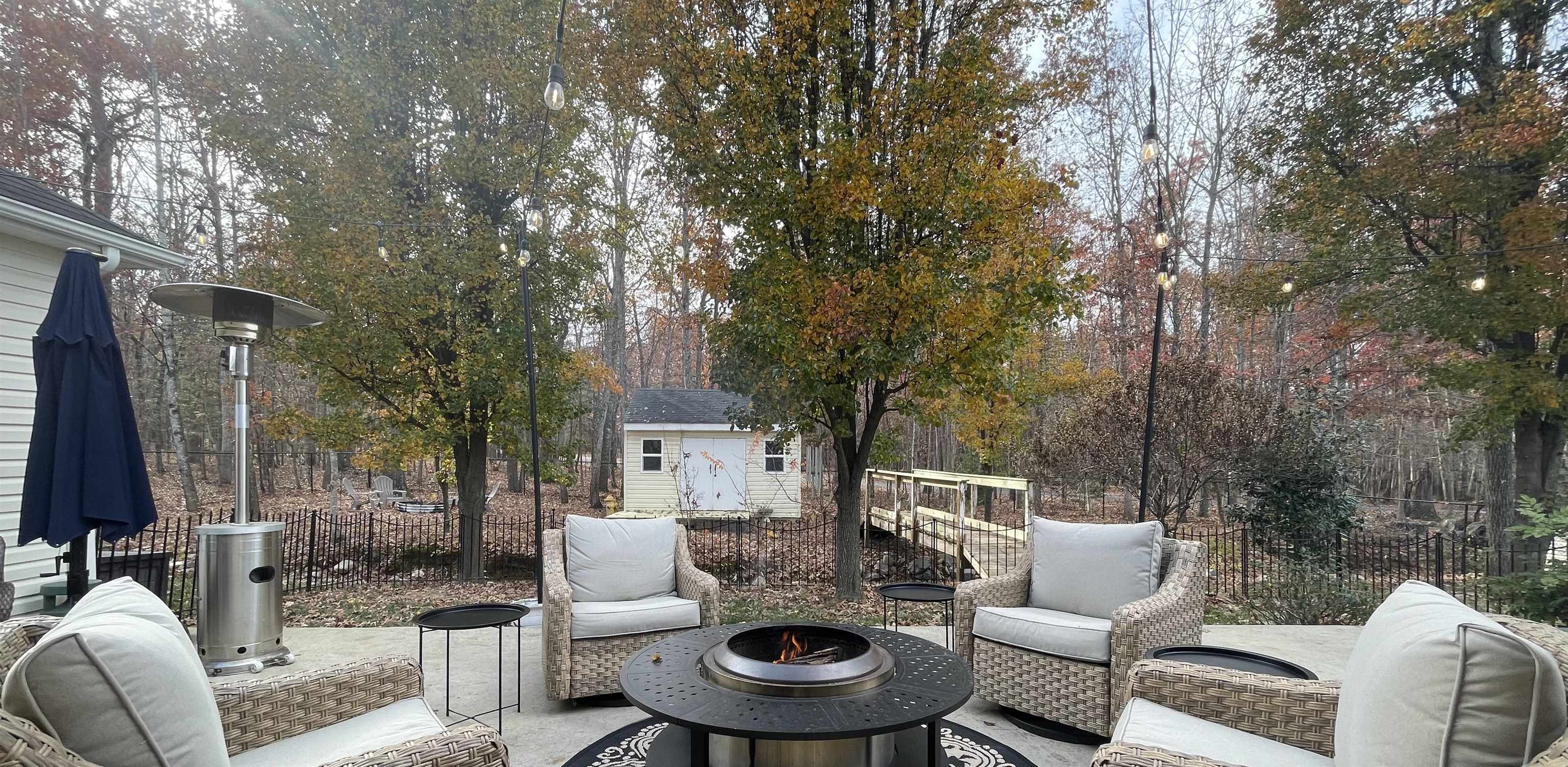 111 Rutherford Lane Stuarts Draft, VA 24477 - Photo 40 of 45 a patio with couches a fire pit and large trees