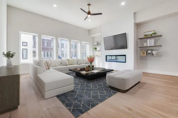 a living room with furniture and a wooden floor