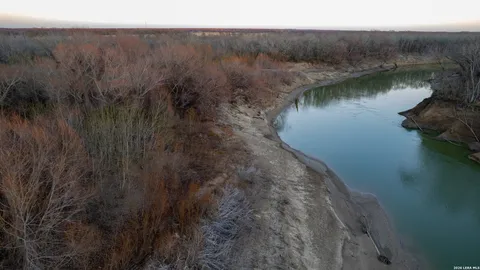 a view of a lake in middle of forest