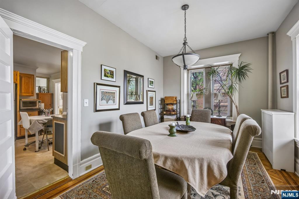 57 Union Street, Unit C4021 Montclair, NJ 07042 - Photo 8 of 20 a dining room with furniture a chandelier and window