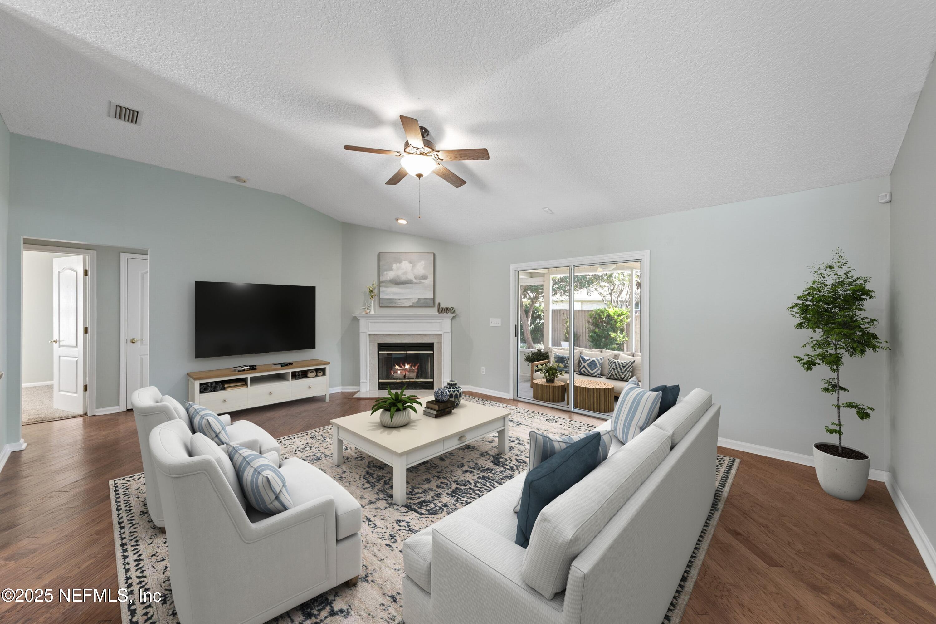 9317 Beresford Court Jacksonville, FL 32244 - Photo 11 of 55 a living room with furniture flat screen tv and a fireplace