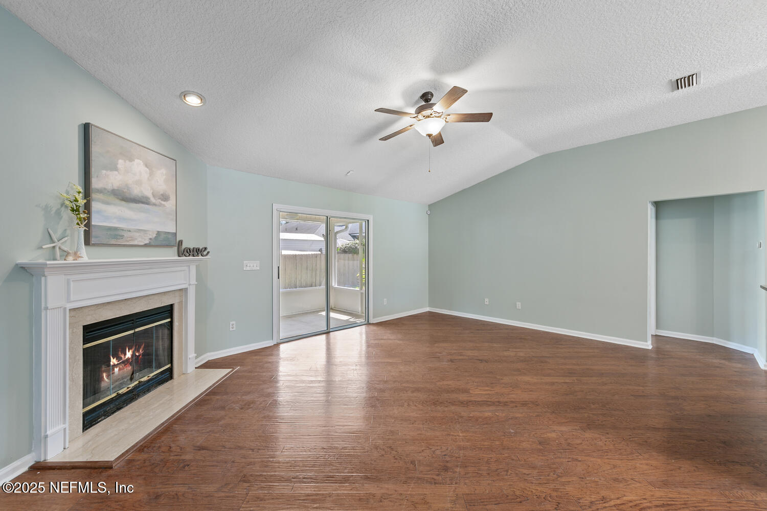9317 Beresford Court Jacksonville, FL 32244 - Photo 13 of 55 a view of an empty room with a fireplace and a window