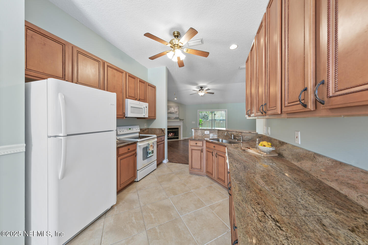 9317 Beresford Court Jacksonville, FL 32244 - Photo 16 of 55 a kitchen with a refrigerator a stove top oven a sink and dishwasher