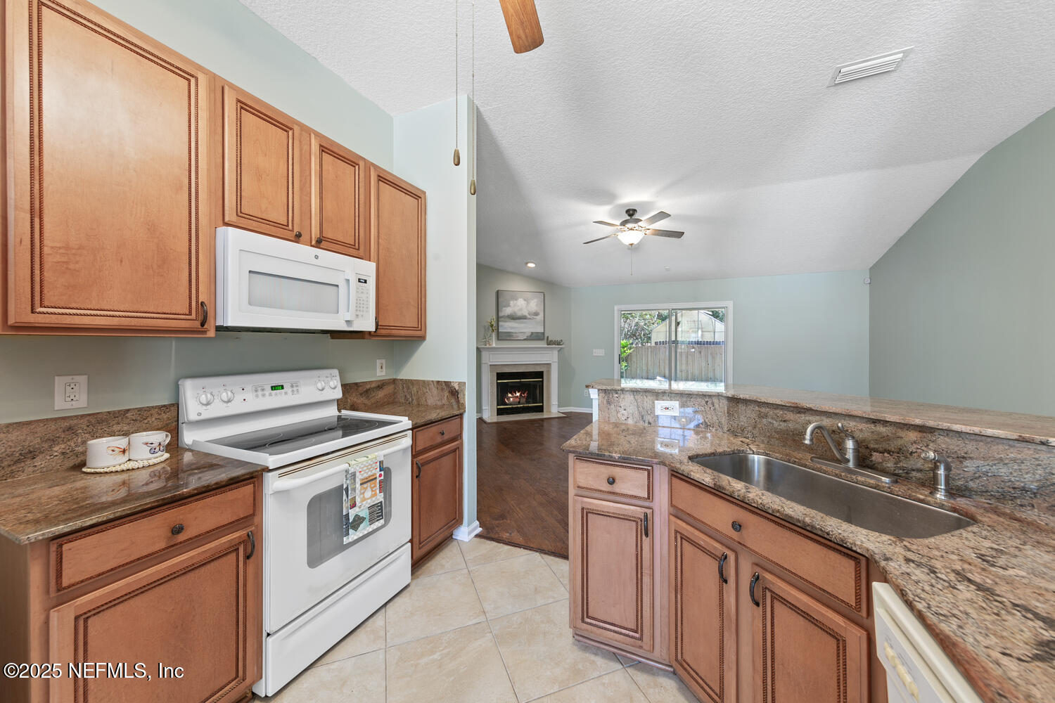 9317 Beresford Court Jacksonville, FL 32244 - Photo 17 of 55 a kitchen with stainless steel appliances granite countertop a sink stove and refrigerator