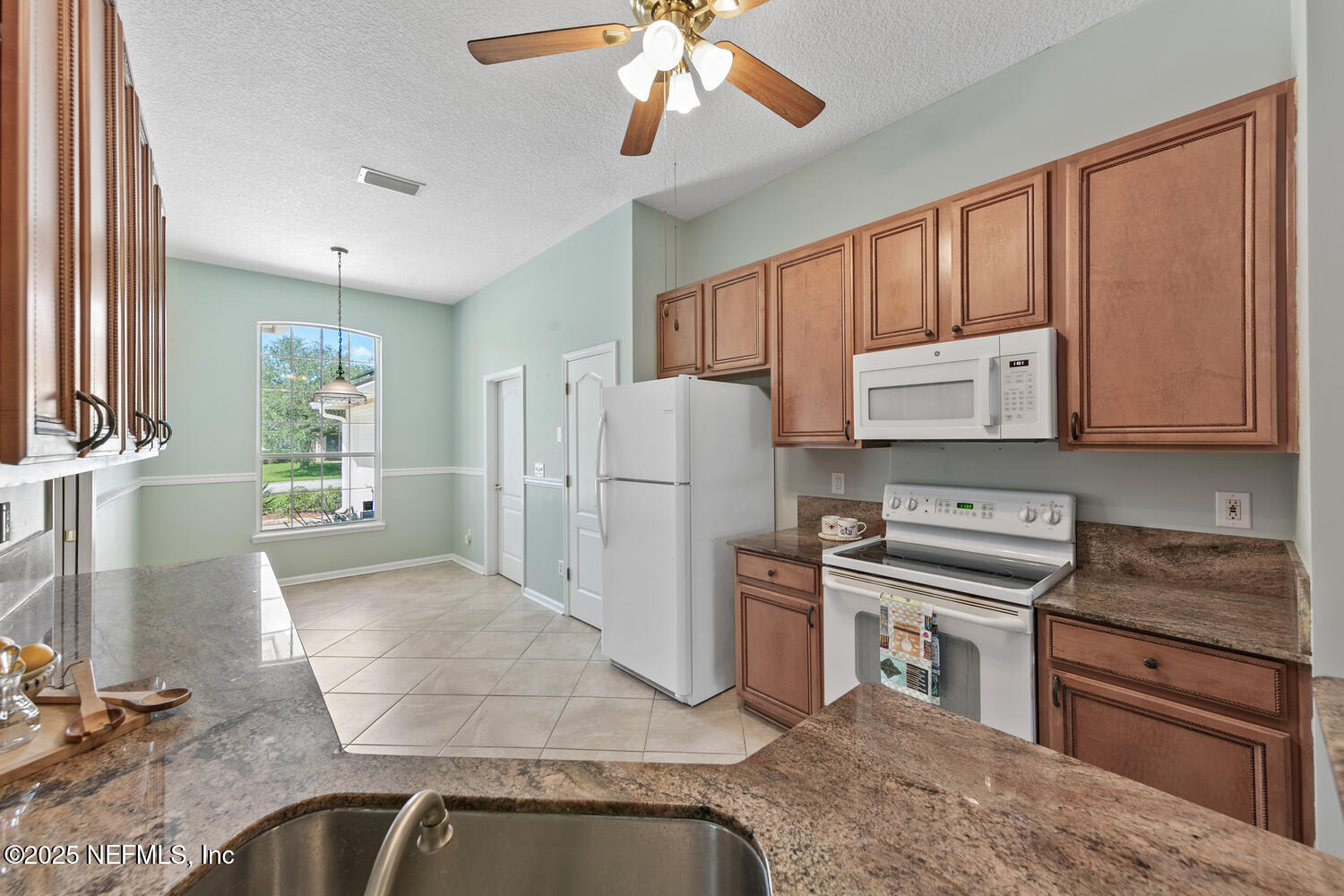 9317 Beresford Court Jacksonville, FL 32244 - Photo 18 of 55 a kitchen with a refrigerator sink and cabinets
