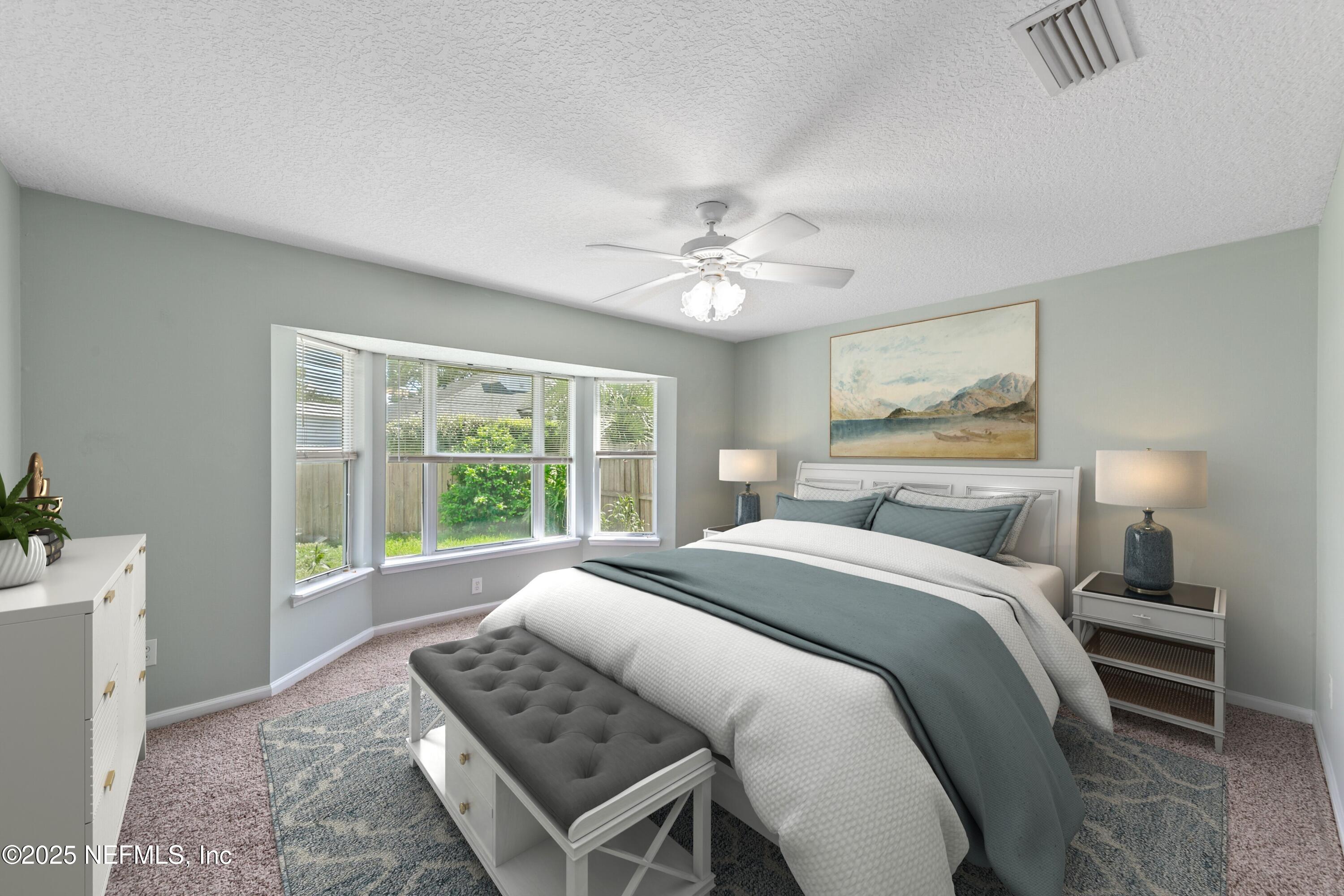 9317 Beresford Court Jacksonville, FL 32244 - Photo 26 of 55 a spacious bedroom with a bed and a window